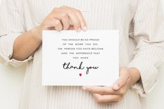 a person holding a thank you card in their hands