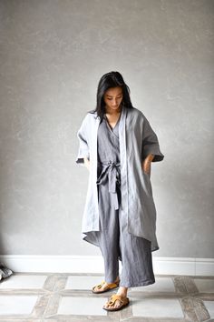 "ODETTE kimono linen coat is an asymmetrical design with two deep side pockets. This linen jacket is elegant, comfortable and so versatile - the design is available in 3 sizes. ODETTE asymmetrical linen jacket is not only comfortable but also eco-friendly and sustainable, making it the perfect choice for anyone looking to reduce their environmental impact. ▶ FIT ODETTE linen duster is of loose design and we offer it in 3 sizes. ▸ The model is wearing size S/M, color Light gray ▶ FABRIC: 100% lin Casual Outerwear With Kimono Sleeves, Casual Outerwear With Kimono Sleeves And Pockets, Casual Linen Kimono With Relaxed Fit, Long Sleeve Kimono With Pockets For Loungewear, Relaxed Fit Long Linen Outerwear, Fall Linen Outerwear For Loungewear, Fall Linen Loungewear Outerwear, Oversized Kimono With Pockets And Kimono Sleeves, Oversized Cotton Kimono With Pockets