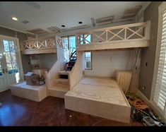 there is a bunk bed in the middle of this living room with stairs to the second floor