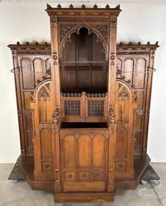 an old wooden cabinet with carvings on the doors