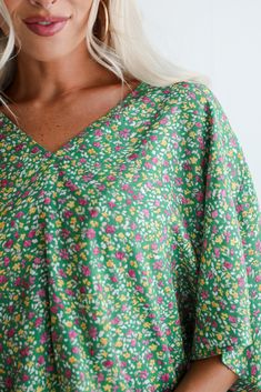 With the sun on your shoulders and wind in your hair, float through the day in the Perfect Whimsy Green Floral Oversized Blouse! Crafted from lightweight, breathable fabric, this blouse is perfect for adding a touch of botanical charm to your everyday style. The blouse features a delightful green hue that evokes a sense of tranquility and vitality, complemented by a vibrant floral pattern in shades of white, pink, and yellow. This intricate floral design adds a playful and feminine touch to the Oversized Printed Summer Blouse, Oversized Floral Print Tops For Summer, Oversized Floral Print Summer Tops, Green Short Sleeve Blouse For Beach, Green Relaxed Fit Blouse For Beach, Oversized Green Blouse For Day Out, Relaxed Fit Green Blouse For Beach, Spring Green Flowy Blouse, Green Flowy Blouse For Vacation