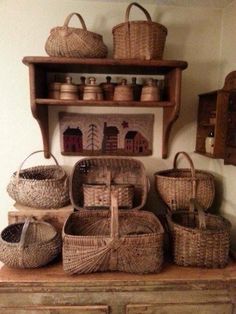 wicker baskets are stacked on top of an old dresser