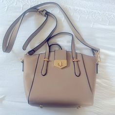 Tan Cross Body Bag. Perfect For Any Outting/Occasion. Never Used. Brand New. Zippers Still Have The Plastic Protectors On From When It Was Bought. Brand Unknown. 11 Inches-Width 8 Inches -Height Light Brown Crossbody Satchel With Adjustable Strap, Beige Shoulder Bag With Metal Hardware, Beige Top Handle Bag With Metal Hardware, Beige Satchel Shoulder Bag With Metal Hardware, Beige Tote Satchel With Metal Hardware, Beige Tote Bag With Metal Hardware, Beige Bags With Metal Hardware And Double Handle, Beige Satchel Bag With Metal Hardware, Beige Crossbody Satchel