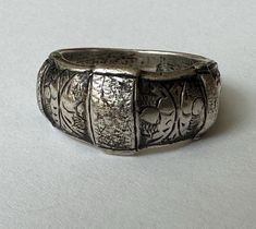 another piece that i've had sitting here with me for a long time because i adore it... a sterling ring from Siam, likely in the 1940's.  it has wondrous texture and hand engraving and a bit of a dome.  it has nice weight and is marked Siam Sterling.  it's also marked 7, for the size, but due to its width i prefer it as a 6.75.  it has some wear on the inner band but mostly very nice condition. size:  6.75-7 height of face;  3/8" width of inner band:  between 2 and 3/16" weight:  9.6g Here With Me, Metal Work, Hand Engraving, Sterling Ring, Metal Working, Favorite Jewelry, Band Rings, Beauty Book, Jewelry Rings