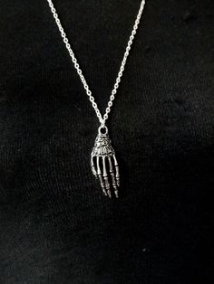 "Skeleton hand charm necklace, Punk necklace, Grunge jewelry This listing is for a striking skeleton charm necklace on long silver plated chain. Measurements: Length - 27\" Skeleton hand charm - 41mm x 16mm Please contact me if you have any questions.    Thanks for looking. To view other necklaces, please click here http://www.etsy.com/uk/shop/GemmaJolee?section_id=13763885 To view other items in the shop click here http://www.etsy.com/uk/shop/GemmaJolee?ref=si_shop" Punk Necklace Aesthetic, Grunge Jewellery, Grunge Necklaces, Necklace Grunge, Grunge Necklace, Emo Jewelry, Skeleton Necklace, Cool Necklace, Punk Necklace