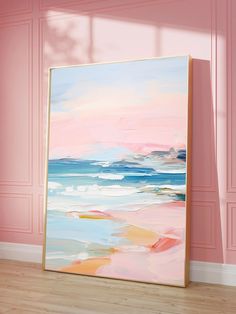 an abstract painting is displayed in front of a pink wall