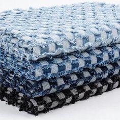 four blue and black towels stacked on top of each other