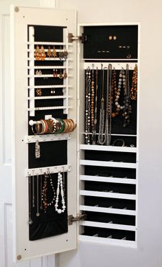 a white cabinet filled with lots of jewelry