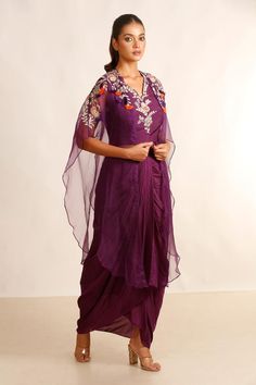 Purple sheer cape with placement floral and tassel work. Paired with an inner blouse with floral embroidery and draped skirt.
Components: 3
Pattern: Embroidery
Type Of Work: Floral
Neckline: Blouse: V Neck
Sleeve Type: Blouse: Sleeveless
Fabric: Silk Muslin And Organza 
Color: Purple
Other Details: 
Length:
Cape: 38 inches
Skirt: 40 inches
Blouse: 18 inches
Closure: Side zip
Occasion: Sangeet - Aza Fashions Sheer Cape, Draped Skirt, Blouse Sleeveless, Pattern Embroidery, Purple Silk, Fabric Silk, Set For Women, Aza Fashion, Fashion Set