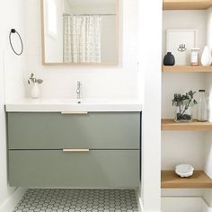 a bathroom with shelving, sink and mirror