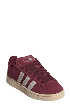 Serrated 3-Stripes and matching Trefoils stand out on this suede sneaker featuring extrasoft cushioning on the tongue and cuff for a skate-inspired twist. Lace-up style Leather or leather and textile upper/textile lining/rubber sole Imported Maroon Shoes, Adidas Campus 00s, Burgundy Shoes, Adidas Campus, Red Sneakers, Red Stripe, Suede Sneakers, Christmas Wishlist, Up Styles