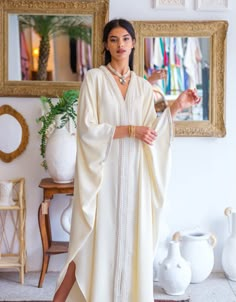 Elevate your wardrobe with our " Embellished Crepe Kaftan ," a stunning crepe kaftan that embodies the essence of Moroccan elegance and craftsmanship.   Product Details:     Crafted from Premium Crepe: This kaftan is made from 100% crepe, ensuring a lightweight and comfortable feel against your skin.    Signature Moroccan Embellishments: Adorned with intricate golden "sfifa" and delicate pearls, this kaftan is a masterpiece of Moroccan design. The embellishments add a touch of opulence and tradi Moroccan Outfit, Silk Abaya, Morrocan Fashion, Kaftan Styles, Moroccan Clothing, Kaftan Designs, Moroccan Kaftan, Moroccan Fashion, Muslim Women Fashion