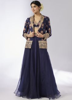 This elegant navy blue lehenga set features a floral embroidered jacket paired with a matching blouse and a flowing skirt. The intricate detailing and sophisticated design make it a perfect choice for festive occasions and weddings. Elegant Floor-length Skirt Set With Zari Work, Elegant Designer Zari Work Skirt Set, Elegant Designer Skirt Set With Zari Work, Elegant Festive Saree Skirt Set, Elegant Floor-length Skirt Set With Dupatta, Elegant Skirt Set With Zari Work For Festive Occasions, Formal Festive Palazzo Set With Intricate Embroidery, Elegant Festive Skirt Set With Zari Work, Festive Formal Palazzo Set With Intricate Embroidery