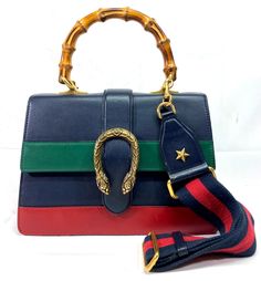 >>FOR SALE<< >>PRE-OWNED<<   Gucci 448075 Dionysus Bamboo Top Handle Colorblock Leather Black/Green/Red Shoulder Bag Bag Sizes - Long - 10.5" Dept - 3" Height - 7.5" Strap Size - 20" + Adjustable Condition - Overall Bag is in a Good Cosmetic Condition! Has Some Sign of Normal Use! Bag Has Few Light but Visible Spots. Strap is in a Great Condition. Strap Has Some Stains on Leather. Interior Has Multiple Stains from Normal Use! Interior is in Acceptable Used Condition! Please Refer to Photos for More Info! ATTENTION: PRE-OWNED WITHOUT TAGS Comes Without Original Box Comes Without Original Dust Bag COMES AS PICTURED PLEASE REVIEW PICTURES FOR CLOSER DETAILS AWESOME DESIGN THIS MODEL WON'T LAST LONG!!! Condition Description: This item is pre-owned. Please refer to pictures for a better underst Red Shoulder Bag, Bamboo Top, Bag Bag, Handle Bag, Leather Interior, Black Green, Size 20, Top Handle, Color Blocking