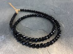 Black Onyx Beaded Necklace, Black Onyx Choker Necklace DETAILS - 4mm Black Onyx Beads - 14K Gold Filled Spring Ring Clasp 5mm - 14K Gold Filled 2 inches Extender Chain - Necklace Length 14 - 16 inches Please note: Because we use natural stones, the stones may vary slightly in shape, shade and size. They may also contain natural inclusions. If you have any questions, please feel free to contact me. This natural black onyx necklace is made with small faceted sparkling black gemstone beads to creat Black Crystal Necklaces With Round Gemstone Beads, Black Rondelle Beaded Necklaces, Black Beaded Rondelle Necklace, Black Rondelle Gemstone Bead Necklace, Black Onyx Beaded Necklace With Faceted Beads, Black Single Strand Beads For Jewelry Making, Black Faceted Round Beads, Black Onyx Round Bead Crystal Necklaces, Black Rondelle Gemstone Beaded Necklace