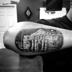 a black and white photo of a man's arm with a building on it