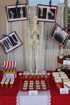 a table topped with pictures and desserts covered in frosting next to a window