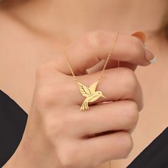 Discover the elegance of our Gold Plated Silver Hummingbird Necklace, a stunning piece of jewelry that captures the beauty of nature. Perfect for any occasion, this necklace is a wonderful gift for bird lovers and those who appreciate fine craftsmanship. Dainty and Stylish. 🌸 Handcrafted Design: Each necklace is meticulously handcrafted, ensuring a unique and high-quality piece. ✨ Premium Materials: Made from sterling silver and plated with gold for a luxurious finish that complements any outfi Elegant Bird Design Jewelry For Gift, Elegant Bird Design Jewelry Gift, Silver Bird-shaped Jewelry As Gift, Silver Bird Shaped Jewelry For Gifts, Silver Bird-shaped Jewelry For Gift, Elegant Bird Design Jewelry For Anniversary, Hummingbird Jewelry, Angel Pendant Necklace, Hummingbird Necklace