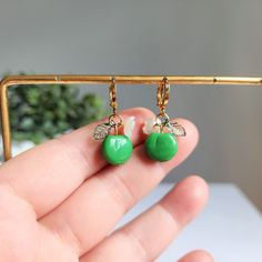 Our green apple huggie earrings are made with glass green apples, acrylic leaves, acrylic flowers and 14K gold plated huggie hoops which are good for delicate ears. Size: approx. 0.5" wide and 1.25" long Trendy Green Dangle Hoop Earrings, Green Dangle Hoop Earrings Hypoallergenic, Green Nickel-free Huggie Earrings, Green Hoop Earrings As A Gift, Trendy Green Dangle Flower Earrings, Green Hypoallergenic Small Hoop Huggie Earrings, Hypoallergenic Green Small Hoop Huggie Earrings, Cute Adjustable Green Earrings, Trendy Green Huggie Hoop Earrings