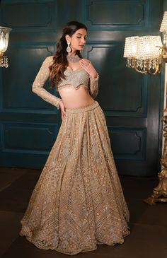 This lehenga set is hand embroidered in floral and geometric motis with a mix of light gold and sequin embroidered. Paired with a full sleeves embroidered wide-neck blouse and match dupatta.DELIVERY TIMEPlease allow 8-12 weeks for your outfit to arrive.FABRIC DETAILSNetProfessional cleaning only. Lehenga Gold, Latest Bridal Lehenga Designs, Cutdana Embroidery, Gold Lehenga, Bridal Lehenga Designs, Latest Bridal Lehenga, Full Sleeve Blouse, Indian Dresses Traditional, Geometric Motifs