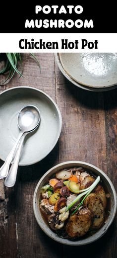 chicken hot pot with potatoes, carrots and mushrooms in it on a wooden table