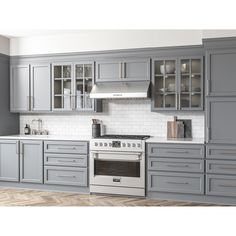 a kitchen with gray cabinets and white counter tops