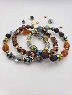 Diffuser Bracelet is comprised of dark brown lava beads, gold colored metal spacers with bronze and metallic glass beads beaded on stretch string.  To see more diffuser bracelets go to my website at https://www.ferdysjoy.com  Measure your wrist where you will be wearing your bracelet.  Flexible tape measure work great but a string wrapped around your wrist will work, too.  Measure the circumference and then lay the string down on a ruler or tape measure to get your wrist size.  Adding desired co Essential Oil Bracelet, Lava Beads, Diffuser Bracelets, Lava Bead, Tape Measure, Bracelet Stack, Ruler, Essential Oil, Snug Fit