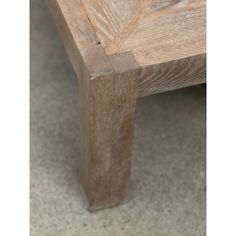 a wooden bench sitting on top of a cement floor