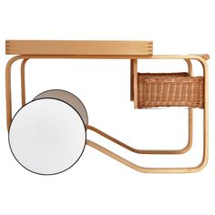 a wooden shelf with a basket on it and a round mirror hanging from the wall