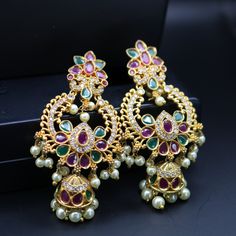 "Exquisite Chandbali earrings handcrafted in brass, adorned with sparkling CZ or shimmering pearls. Timeless elegance for any celebration, from birthdays and anniversaries to festival nights.\" Features: sparkling CZ or shimmering pearls Lightweight and elegant Can be paired with any dress, kurti, or saree Material: Brass Ready to ship from California Free US standard shipping Ready to ship CARE INSTRUCTIONS: 1) Please keep your Jewelry away from moisture and We advise you to do the following things to keep them lasts longer: 2) Please do not wear the jewelry at the time of workout to avoid accidental damage, while using hairspray and perfume. 3) Keep your jewelry away from chemicals. 4) Store jewelries separately, Different kinds of metal react together. To avoid this, store the jewelry i Festive Jeweled Chandbali Pearl Earrings, Elegant Jeweled Earrings For Diwali, Gold Jeweled Chandbali Pearl Earrings, Jeweled Drop Earrings For Festivals, Elegant Pearl Earrings With Dangling Beads For Festivals, Jeweled Pearl Earrings For Festivals, Jeweled Pearl Earrings For Festive Occasions, Jeweled Drop Danglers For Festivals, Gift Stone Work Pearl Drop Earrings