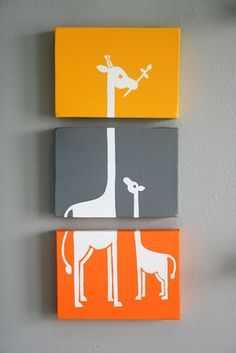 three giraffes and a dog are painted on canvases mounted to the wall