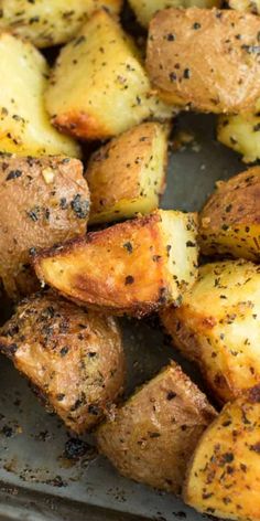 roasted potatoes with herbs and seasoning in a baking pan