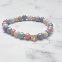 Introducing Our Pastel and Heart Bead Bracelet Our "Sweetheart" Pastel and Heart Bead Bracelet offer a unique combination of vibrant pastel shades and adorable heart details. These beautiful accessories are crafted with care, utilizing and are perfect for showing someone (or yourself) some love. PURCHASE OPTIONS Can be purchased individually - individual bracelets are listed by heart bead metal OR You can purchase them as a stack set. If you do, you will receive a 10% price discount on all the b Rose Gold Bracelets With Round Beads For Valentine's Day, Dainty Rose Gold Bracelets With Heart Beads, Adjustable Rose Gold Charm Bracelet With Heart Charm, Rose Gold Beaded Bracelets With Heart Charm As Gift, Hypoallergenic Heart-shaped Beaded Bracelets For Everyday, Everyday Hypoallergenic Heart Beaded Bracelets, Mother's Day Heart Bracelet With Round Beads, Adjustable Hypoallergenic Heart Beaded Bracelets, Adjustable Hypoallergenic Heart-shaped Beaded Bracelets