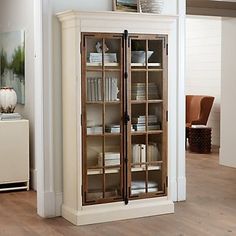 a bookcase with glass doors in a living room