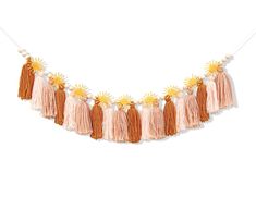 an orange and white tasselled garland with sunflowers