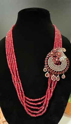 This necklace is a statement piece with a beautiful red/magenta shade and comes with a matching pair of earrings. The length can be adjusted accordingly. Handmade Ruby Jewelry Sets, Handmade Ruby Jewelry Sets In Elegant Style, Elegant Handmade Ruby Jewelry Sets, Pink Ruby Necklace For Party, Elegant Red Necklace With Detachable Pendant, Elegant Ruby Jewelry Sets For Party, Red Long Necklace Jewelry For Gifts, Red Ruby Jewelry Sets For Party, Ruby Jewelry Sets For Party