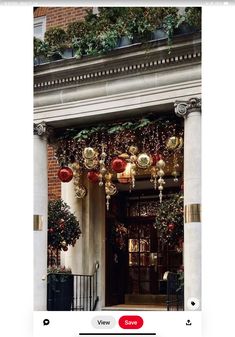 an image of christmas decorations on the front door of a building with red and gold ornaments hanging from it