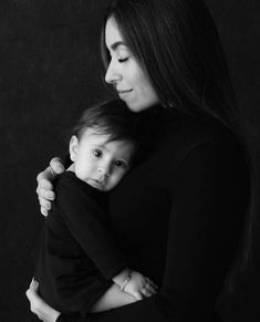 a woman holding a baby in her arms