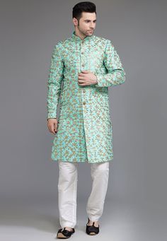 Ready-made Art Silk Sherwani in Turquoise Color. Crafted in Chinese Collar and Full Sleeves, this Ready-made attire with Satin Lining is Enhanced with Buttons, Pockets, Sequins and Zari Work. Available with a Art Silk Pant in White Color.   Do note: Footwear, Stole and Kanthimala shown in the image is for presentation purposes only. Half to one inch may vary in measurement. (Slight variation in actual color vs. image is possible)           We sell all kinds of menswear. Mens Sherwani | Art Silk Green Bandhgala With Zari Work For Navratri, Green Ceremonial Kurta For Navratri, Ceremonial Green Kurta For Navratri, Pista Green Dabka Work Sherwani For Transitional Season, Traditional Pista Green Sherwani With Dabka Work, Green Salwar Kameez For Ceremonial Festive Occasions, Pista Green Sherwani With Dabka Work For Festivals, Pista Green Sherwani With Dabka Work For Eid, Green Festive Salwar Kameez For Ceremonial Occasion