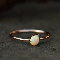 This ring made with genuine opal in solid 14k rose gold,Gemstone Pear Opal Ring Solid 14k Rose Gold Jewelry.Opal Ring, Engagement Ring, Wedding Bands, Gold Ring, Everyday JewelrySpecial customize for Anniversary, Birthday Gift, Valentine, Mother's Day Christmas. Item Details:Gross Weight :- 0.90 Grams14k Rose Gold Weight :- 0.86 GramsOpal Weight:- 0.18 CaratsRing Size:- 7 ( can be customized)Item SKU:- YTR-2163Please let us know if you required in other gemstones which is also possible. This is Pear Opal Ring, Ethiopian Opal Engagement Ring, Champagne Jewelry, Ear Wrap Earrings, 14k Rose Gold Jewelry, Gold Opal Ring, Propose Ring, Rose Gold Opal Ring, Gemstone Diamond Ring