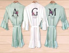 "Sage Green Robe Personalised Bridal robe, Wedding Dressing Gown, Initial Floral Bridal robe, Robes, Satin Wedding Robe, bridesmaid robe These beautiful satin robes are a great addition to any wedding. They are a great thank you gift for the bridal party - bridesmaids, maid of honor, mother of the bride, etc. And they look great in the photographs. They are perfect for the morning of the wedding, hen do or even a spa/pamper day. These can be personalized with names, wedding roles, dates, etc in Green Satin Bridesmaid Gown, Bridal Robes Personalized, Wedding Roles, Wedding Robe, Satin Wedding, Bridesmaid Robes, Bridal Robes, Womens Robes, Morning Wedding