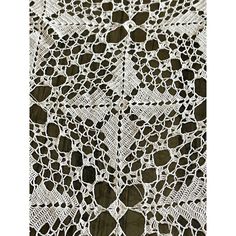 an image of a crocheted doily on a tablecloth with black and white circles