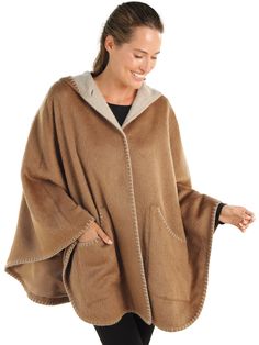 Experience true designer quality without the designer price tag. This luxurious satin-lined cape, 70% suri alpaca and 30% merino wool, wraps you in a cozy all-day caress. Contrasting light and dark Brown interior/exteriors and standout stitching at the edges add striking definition and pique interest—attracting compliments wherever you go. We’ve even added generous pockets so you can mingle with all your essentials. Made in Peru. Cozy Wool Poncho Cape, Luxury Winter Poncho, Luxury Wool Cape For Winter, Cashmere Cape For Winter, Luxury Wool Winter Cape, Cozy Alpaca Cape For Winter, Elegant Beige Cape Poncho, Cozy Alpaca Poncho Cape, Cozy Oversized Cashmere Cape