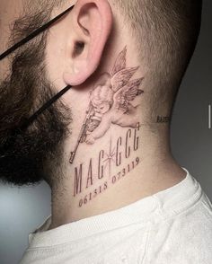 a man with a tattoo on his neck and behind the ear that reads maggo