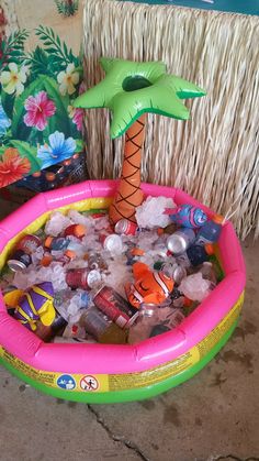 an inflatable palm tree sitting on top of a pool filled with plastic bottles