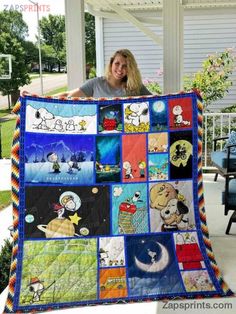 a woman is holding up a quilt made to look like peanuts and snoop the dog