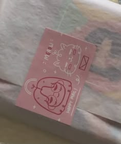 a hello kitty sticker sitting on top of a piece of paper next to an envelope