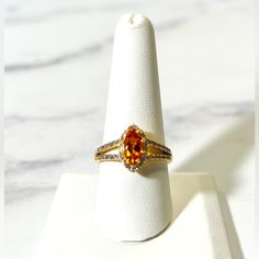 0.79ct Marquise Madeira Citrine With 0.29ctw Round Zircon 18k Yellow Gold Over Sterling Silver Ring. Measures Approximately 0.78"L X 0.52"W. Primary Stone Gemstone Color: Orange Gemstone Classification: Natural Gemstone Ctw: 0.79 Gemstone Dimensions: 10.00mm L X 5.00mm W Gemstone Enhancement: Heated Gemstone Full Name: Madeira Citrine Material Composition: Natural Origin Country: Brazil Gemstone Shape: Marquise Accent Stone(S) Gemstone Color: White Gemstone Classification: Natural Gemstone Ctw: Cubic Zirconia Wedding Rings, Infinity Diamond Ring, Marquise Ring, Fancy Rings, Vintage Sterling Silver Rings, Vintage Diamond Rings, Charm Rings, Size 10 Rings, Vintage Diamond