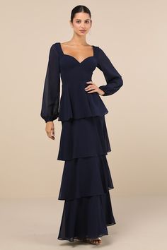 The Lulus Flawless Excellence Navy Blue Tiered Long Sleeve Maxi Dress was made to take everyone's breath away! This luxe dress has a lightweight woven chiffon composition that shapes princess-seamed cups, a V-neckline (and V-back), and slightly sheer, balloon-style long sleeves with elastic at the cuffs. The flattering, set-in waist tops a tiered, A-line skirt that falls to a sweeping maxi hem. A slender tying strap secures at the back, atop a hidden back zipper/clasp. Fit: This garment fits tru Blue Tiered Dress For Gala, Formal Fitted Chiffon Dress With Sweetheart Neckline, Formal Tiered Dress With Fitted Bodice, Fitted Chiffon Dress With Sweetheart Neckline For Formal Occasions, Fitted Chiffon Dress With Lined Bodice, Tiered Chiffon Evening Dress, Fitted Tiered Chiffon Dress, Fitted Chiffon Tiered Dress, Blue Chiffon Dress With Ruffles For Formal Events