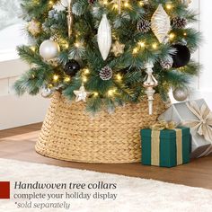 a christmas tree with lights and ornaments in a basket